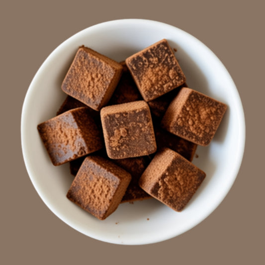 Unrefined sugarcane jaggery cubes from NEUTRIFARM, natural chemical-free sweetener with golden brown color and textured surface.
